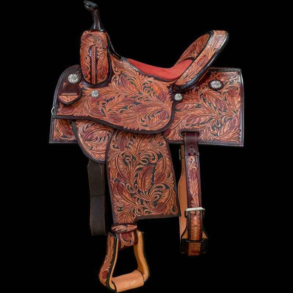 Our Hand Tooled Racer Saddle is a beautiful multitoned feathered Barrel Saddle with customizable conchos and seat color, size and lettering. Personalize this stunning saddle now!